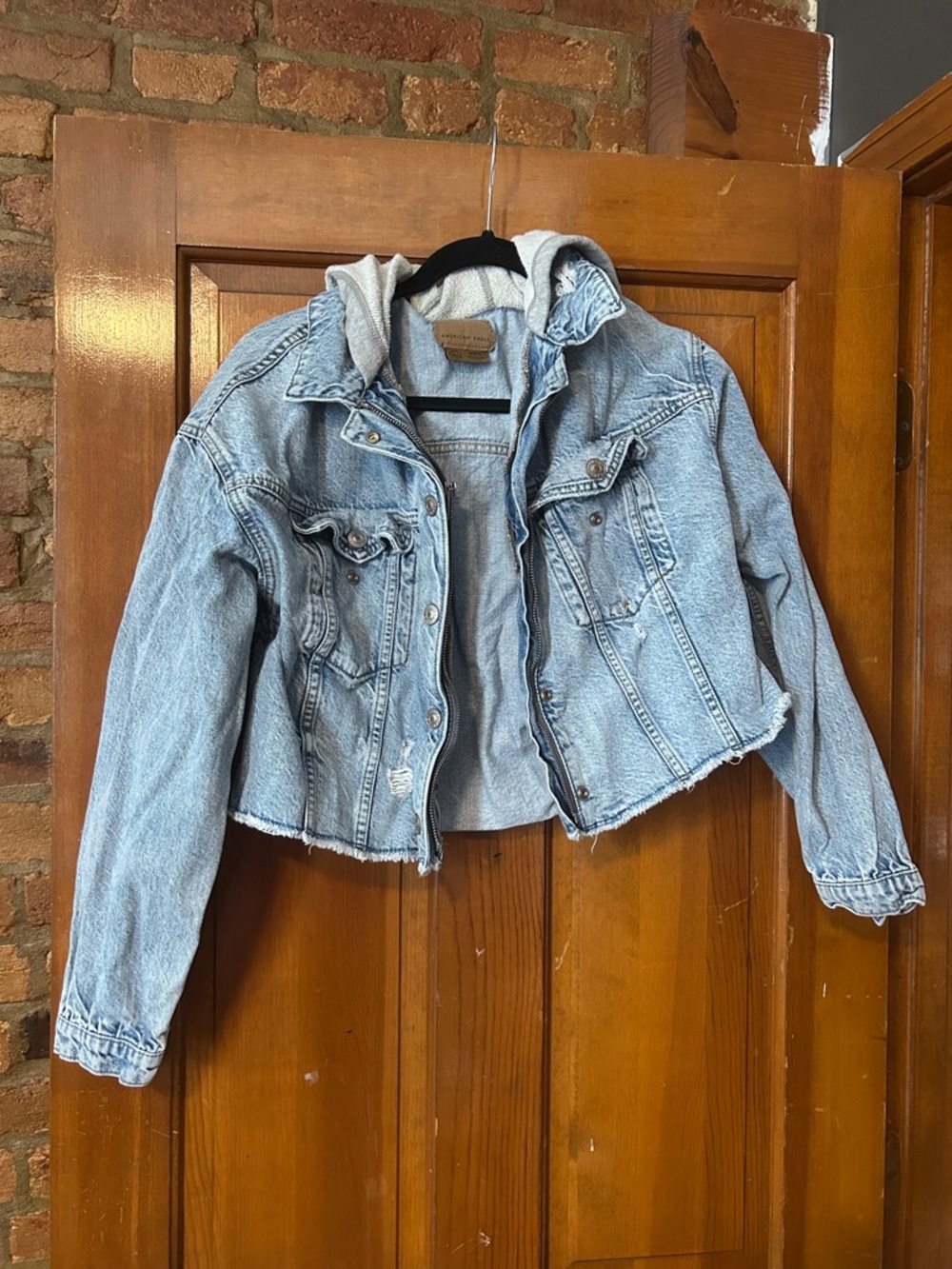 American Eagle light blue denim jacket with gray hood